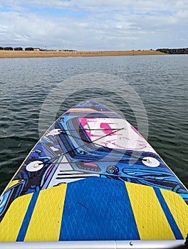 Paddle boarding on the calm sea.