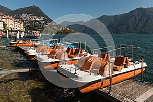 Paddle boats moored on lake Lugano