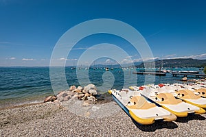 Paddle boats and sailing boats moored on the Lake Garda - Veneto Italy