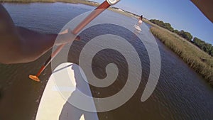 Paddle POV of man stand up paddleboarding