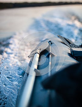 Paddle on the side of a boat with the waves in the background and copy space