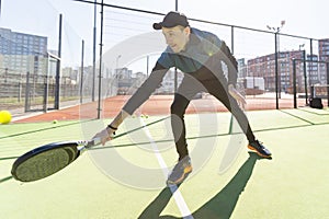 paddle tennis coach teaching on a residential paddle court, front view