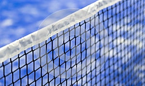 Paddle tennis and tennis net on blue court. Tennis competion concept. Horizontal sport poster, greeting cards, headers, website