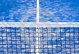 Paddle tennis and tennis net on blue court. Tennis competion concept. Horizontal sport poster, greeting cards, headers, website