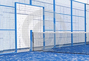 Paddle tennis and tennis net on blue court. Tennis competion concept. Horizontal sport poster, greeting cards, headers, website