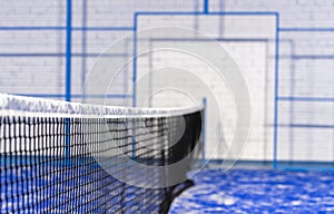 Paddle tennis and tennis net on blue court. Tennis competion concept. Horizontal sport poster, greeting cards, headers, website