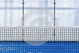 Paddle tennis and tennis net on blue court. Tennis competion concept. Horizontal sport poster, greeting cards, headers, website