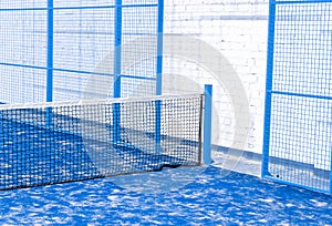 Paddle tennis and tennis net on blue court. Tennis competion concept. Horizontal sport poster, greeting cards, headers, website