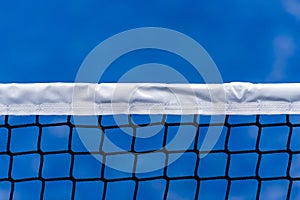Paddle tennis, volleyball and tennis net on blue court. Tennis competion concept. Horizontal sport poster, greeting cards, headers