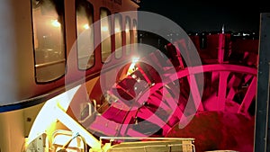 Paddle wheel of tourist steamboat on Mississippi river near New Orleans, Louisiana at night time