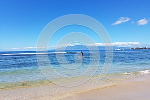 Paddleboarding along Maui shoreline.