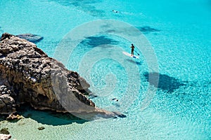 Paddleboarding and snorkeling in the sea. photo