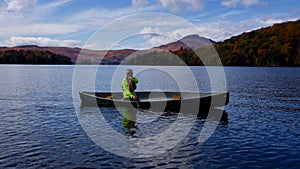 Paddler in Canoe during Autumn on Memphremagog Lake, Quebec, Canada