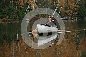 Paddling a Canoe on an Autumn Lake