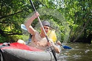 Paddling in kayak in wild river