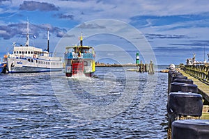 Paddlwheel steamboat painted in old-fashioned, and blue reflects on the waters of a swamp. WarnemÃÂ¼nde