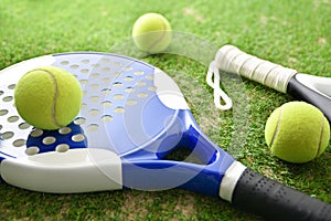 Padel rackets and balls on outdoor artificial grass
