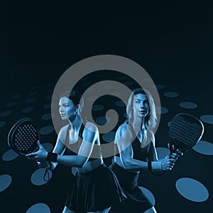 Padel tennis doubles. Two athletes players with racket. Women with paddle racket on court. Sport concept. Download a