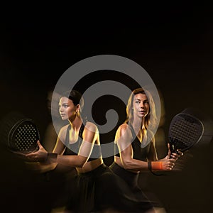 Padel tennis doubles. Two athletes players with racket. Women with paddle racket on court. Sport concept. Download a