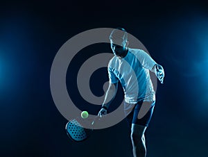 Padel tennis player. Padel open tour. Man athlete with paddle tenis racket and ball on blue background. Sport concept photo