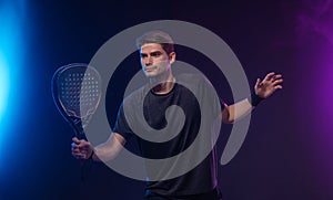 Padel Tennis Player with Racket in Hand. Paddle tenis, on a blue background. Download in high resolution.