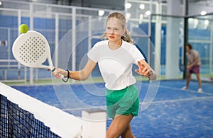 Padel tennis teenage girl in court ready for play