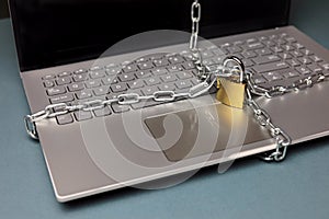 A padlock and chain around a laptop