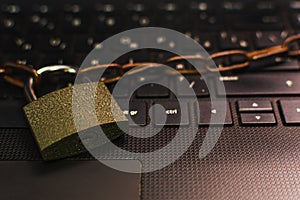 Padlock with chain on laptop keyboard