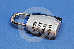 A padlock with combination lock on blue background