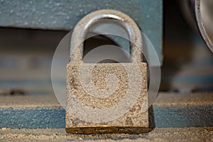 Padlock covered in sawdust in a workshop