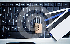 Padlock and credit cards on the computer keyboard. Credit card security