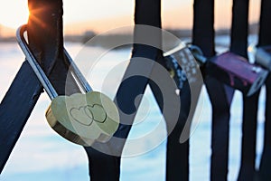 Padlock in the form of two hearts on the bridge of photo
