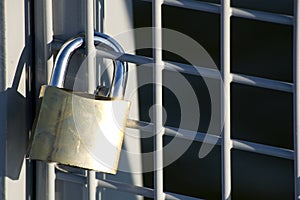 Padlock on gate at construction site - lock on closed fence