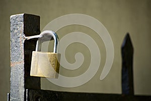 Padlock on gate at construction site - lock on closed fence.