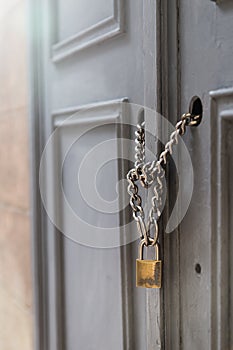 A padlock holding chains in a door/gate