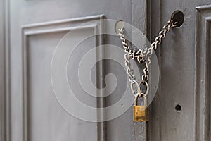 A padlock holding chains in a door/gate