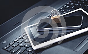 Padlock with laptop, smartphone and tablet. Internet and technology security