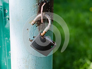 Padlock. Metal gate. Iron fence. Closed door.