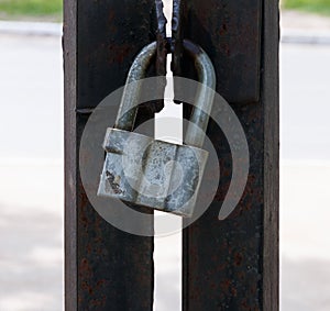 Padlock, old iron hinges on the gate
