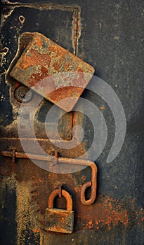 Padlock on old metal door