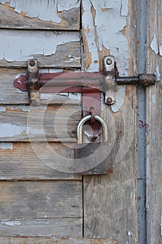 Padlock on a old wooden door.