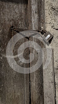 Padlock on an old wooden door