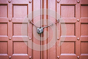 Padlock on a red door