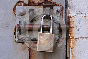 Padlock on Rusty Bolted Door