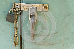 Padlock with rusty chains and green  background vintage style