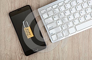 Padlock on a smartphone with a computer keyboard Internet security concept