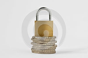 Padlock on stack of coins on white background - Concept of financial security