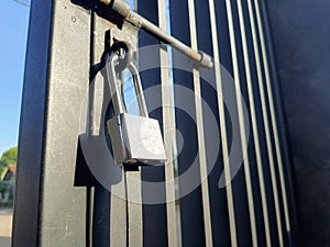 The padlock is still locked on the Black colored fence