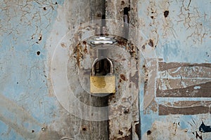 Padlock on vintage door closeup - closed gate