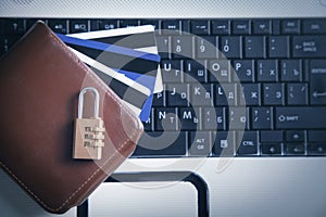 Padlock, wallet and credit cards on the computer keyboard